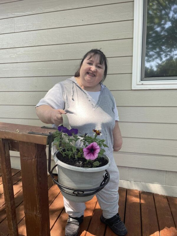 Cammie watering her flowers