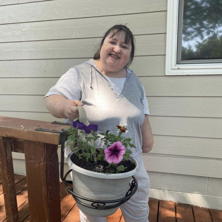 Cammie watering her flowers